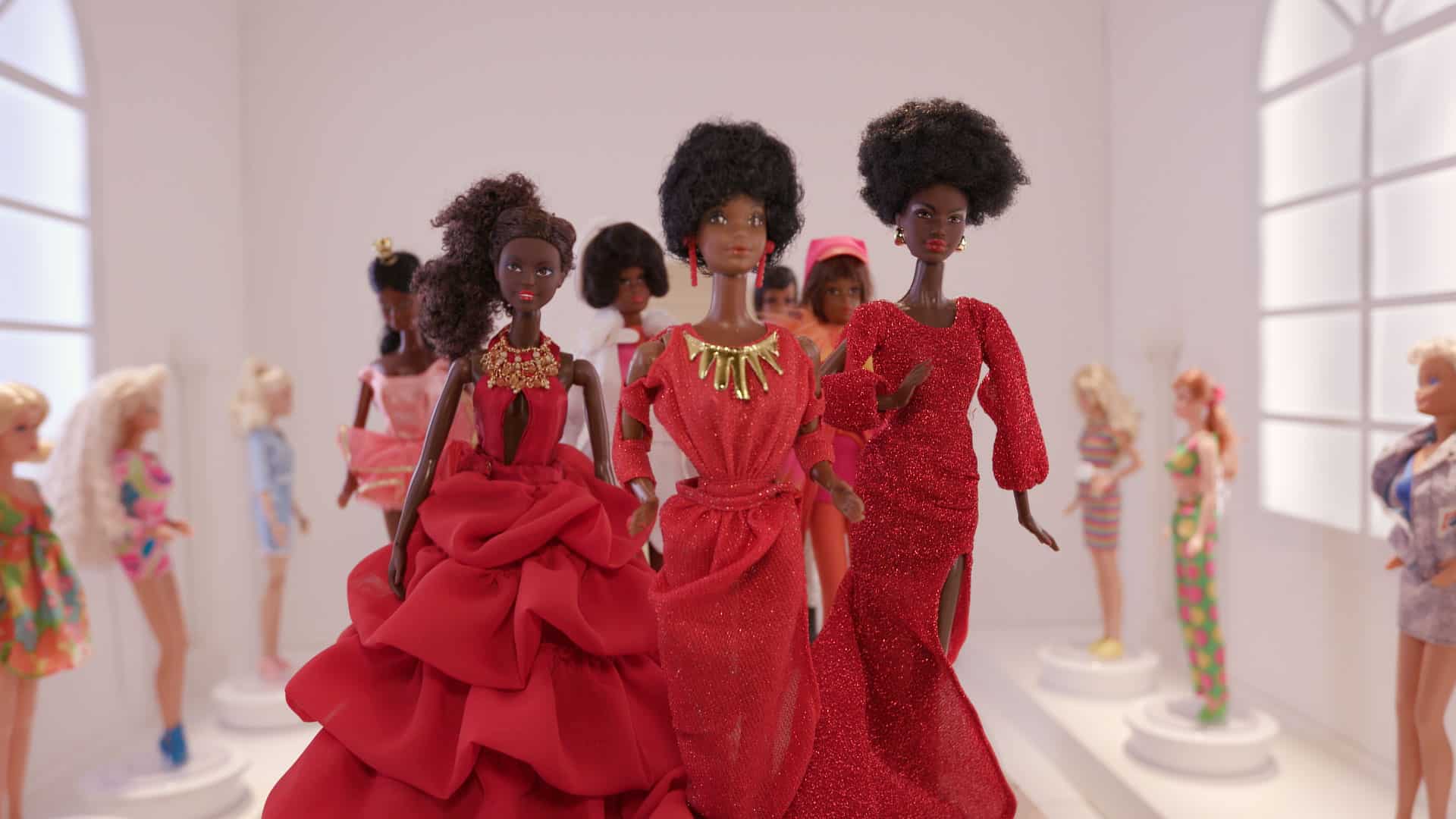 Black Barbies: Walkingt through a gallery, surrounded by the other Barbies that have appeared throughout the history of Mattel